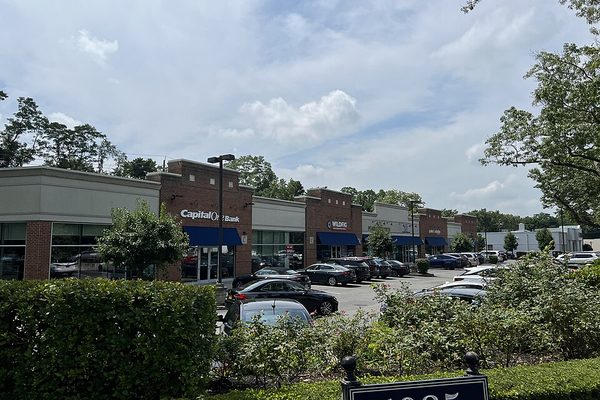 Shopping center with storefronts and a parking lot